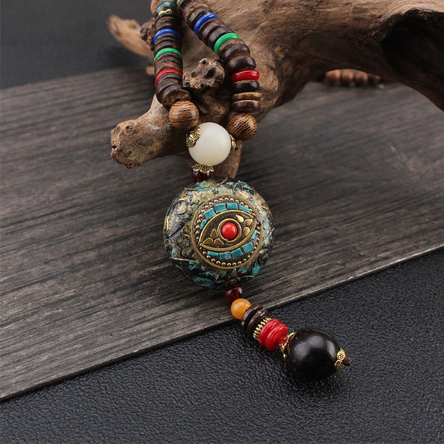 Wisiorek z drewna o długim, vintage'owym designie, dekorowany koralikami, inspirowany etnicznymi stylami Nepal, boho. Ozdobne, okrągłe oko wyróżniające się biżuteria dla kobiet. Idealny jako prezent - Wianko - 1